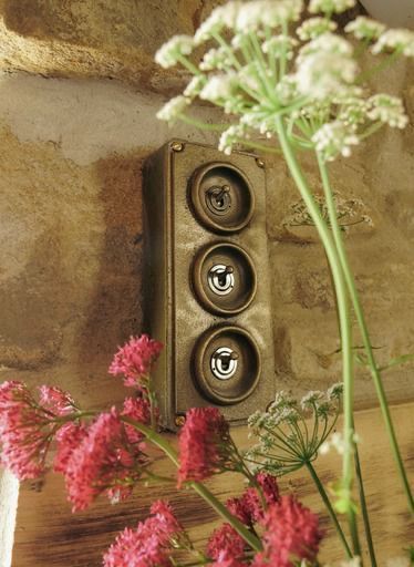 Period-style switches on a stone wall