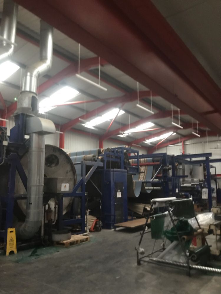 Factory floor with large machines and lighting